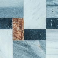 Close-up of a geometric marble tile pattern with natural texture colors.